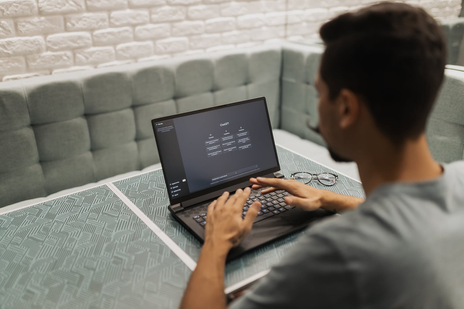 a man is sitting at a table with a laptop